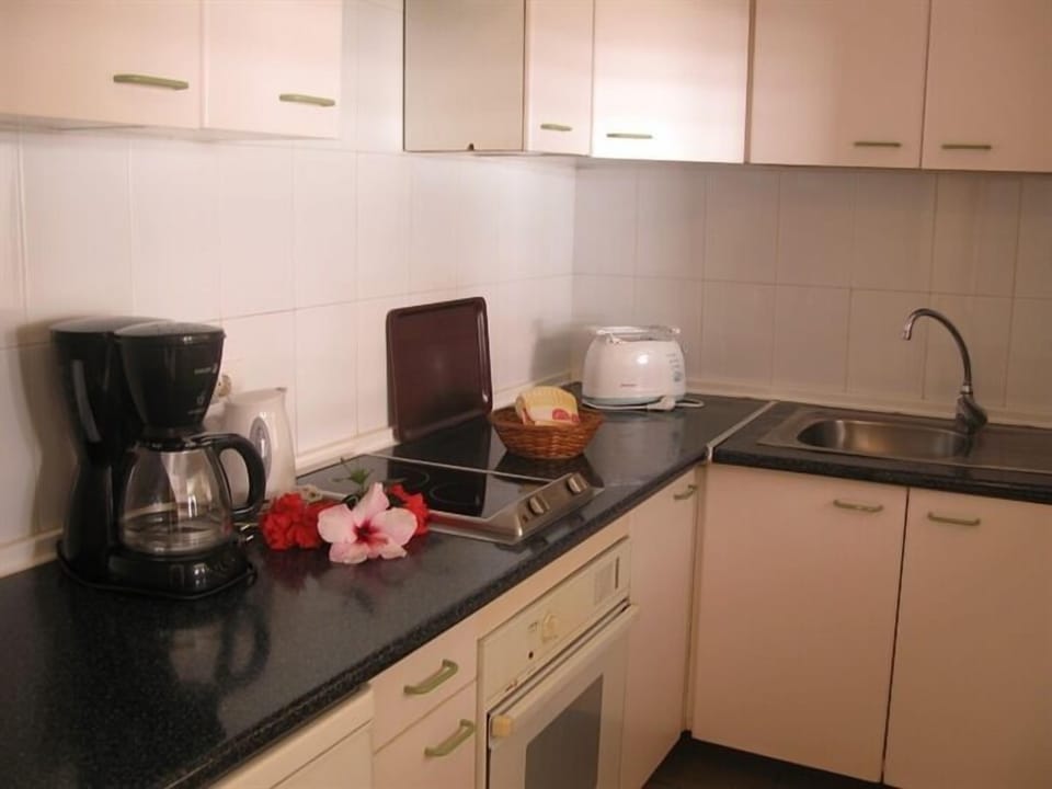 Fridge, stovetop, coffee/tea maker, cookware/dishes/utensils