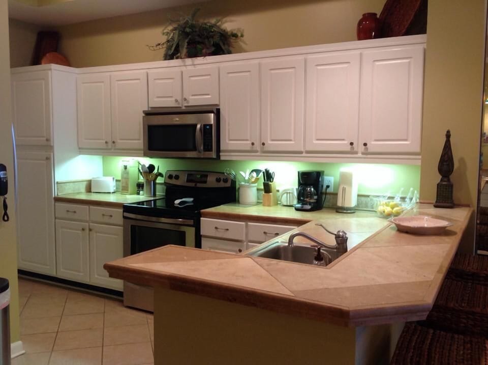 Stainless appliances and tile countertops with all the things you need.