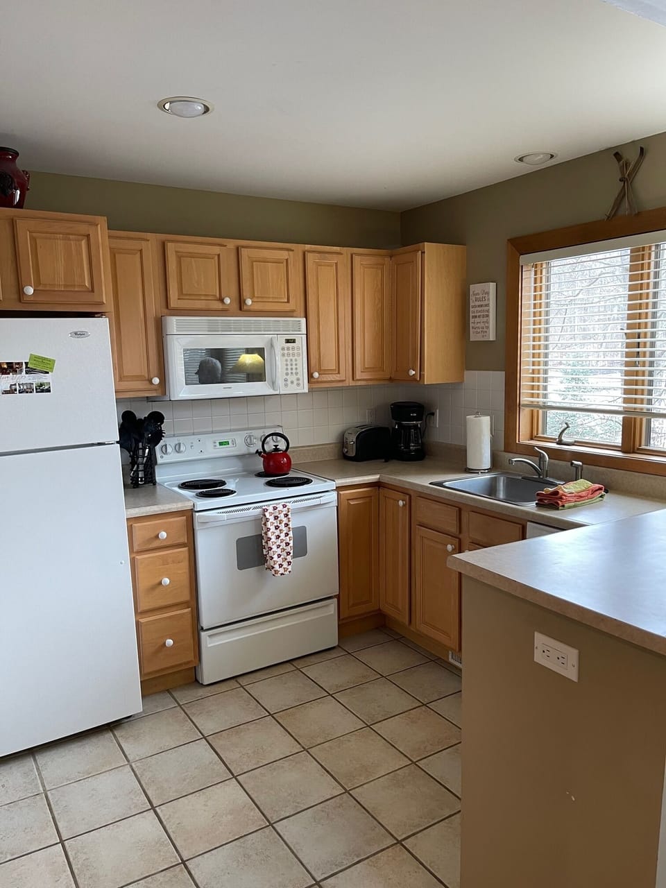 Full kitchen with washer, oven, refrigerator, microwave, and coffee maker