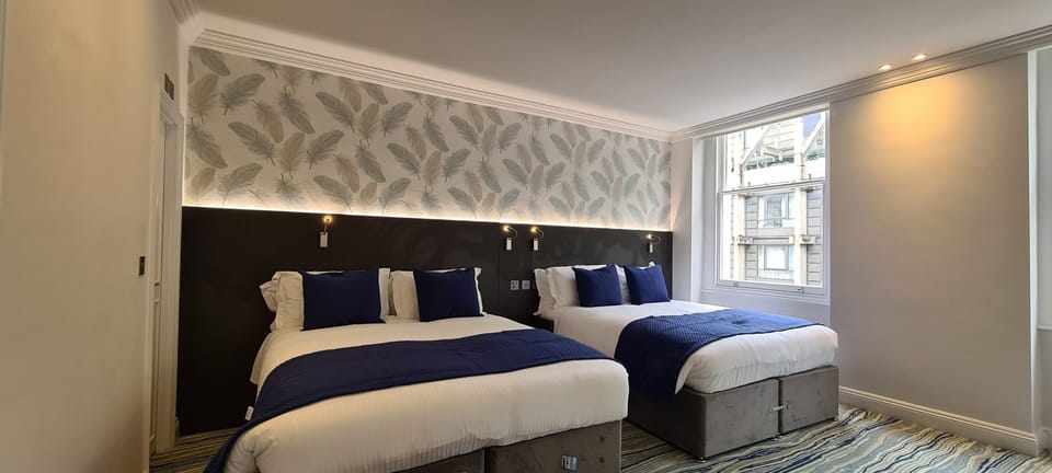 Deluxe Quadruple Room | Hypo-allergenic bedding, in-room safe, desk, iron/ironing board