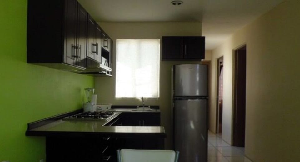 Family Townhome, 2 Bedrooms | Private kitchen | Full-size fridge, microwave, stovetop, cookware/dishes/utensils