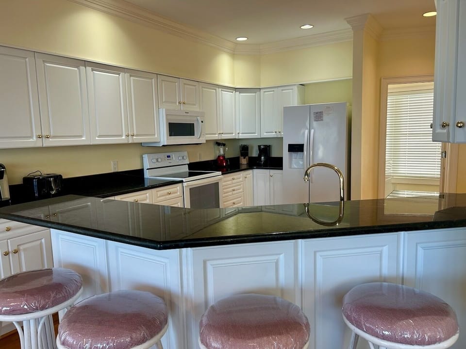 Conveniences of home: expansive kitchen, new appliances and counterfront seating