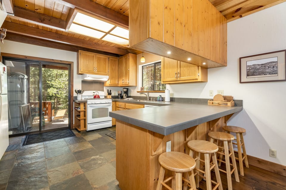 Kitchen has a sliding glass door that opens to grill and back deck