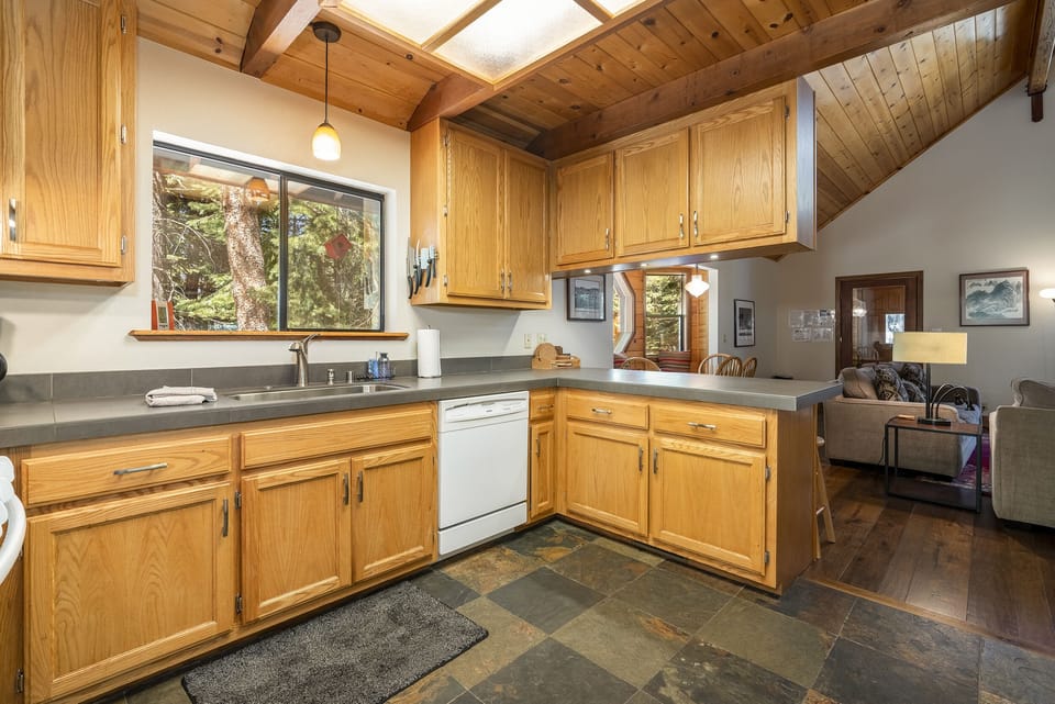 Kitchen with prep space, forest views, and a breakfast bar