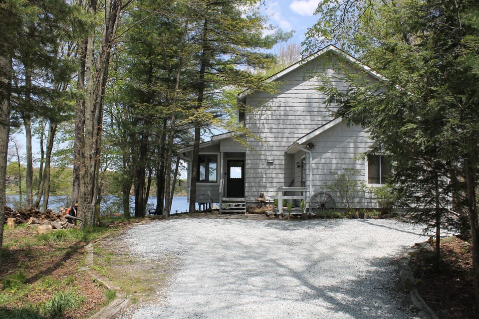 Front of the house with lake behind it