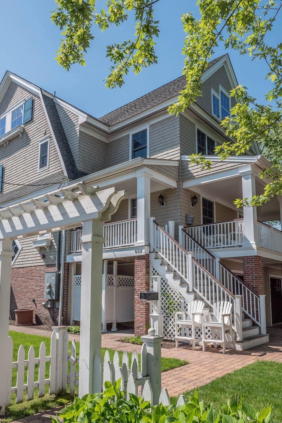 Side view from Jefferson Street showing outdoor showers and Adirondack chairs.