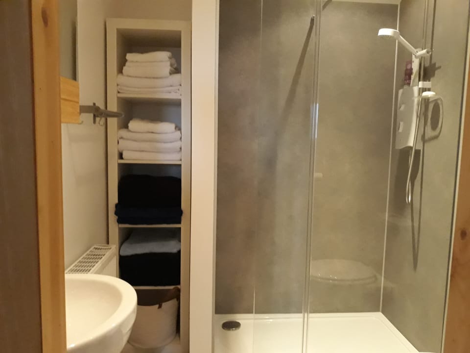 shower room with lots of fluffy towels