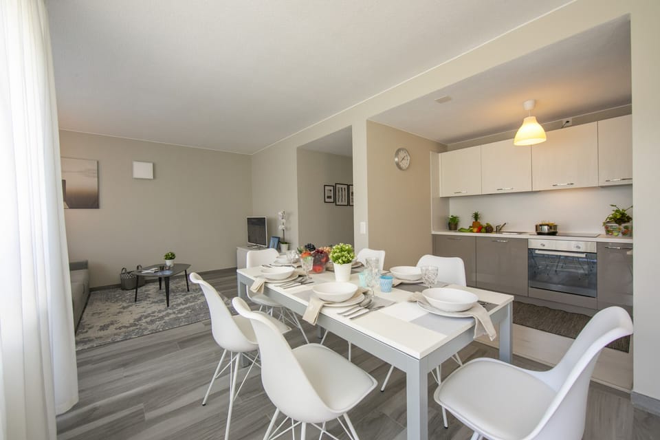 Living room with open plan kitchen and dining set
