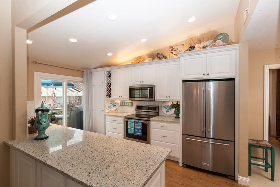 Highly upgraded custom kitchen.   Gorgeous beach glass counter tops. 