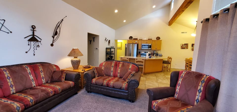 Open floorplan with vaulted ceiling and natural lighting.