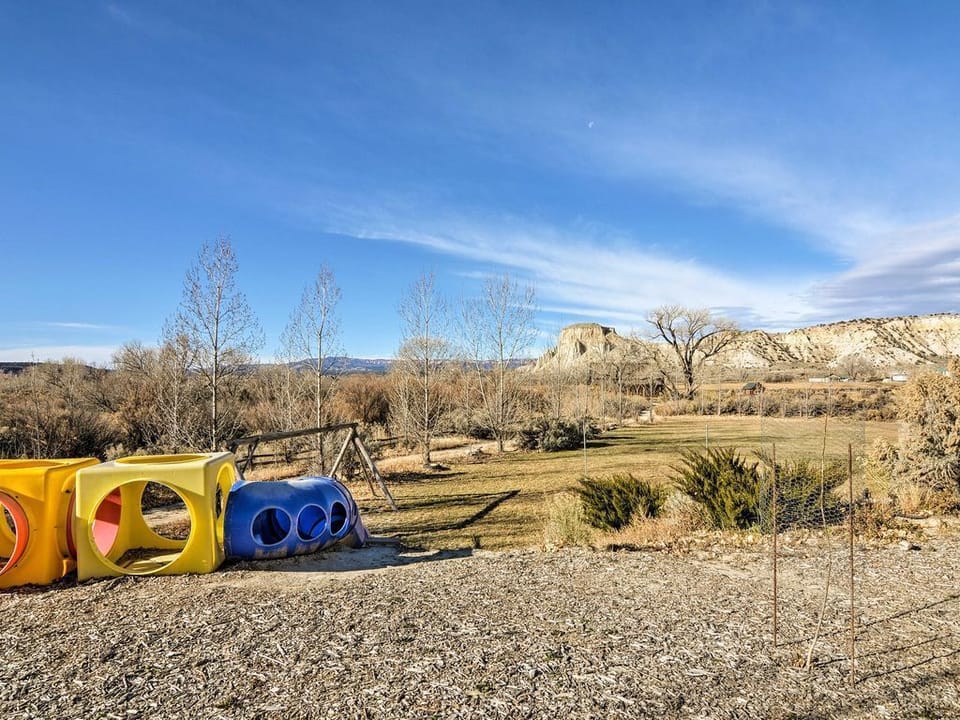 Top of tube slide, with swing set showing in the background.