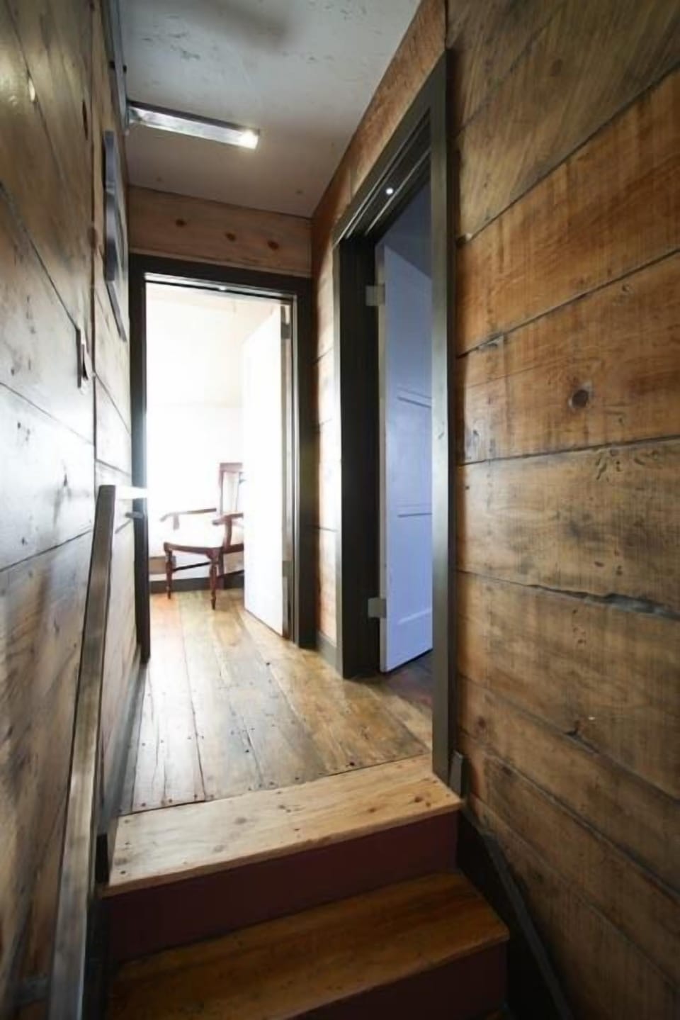 Up to the second floor.  M bed to the R, 2nd bed straight ahead.