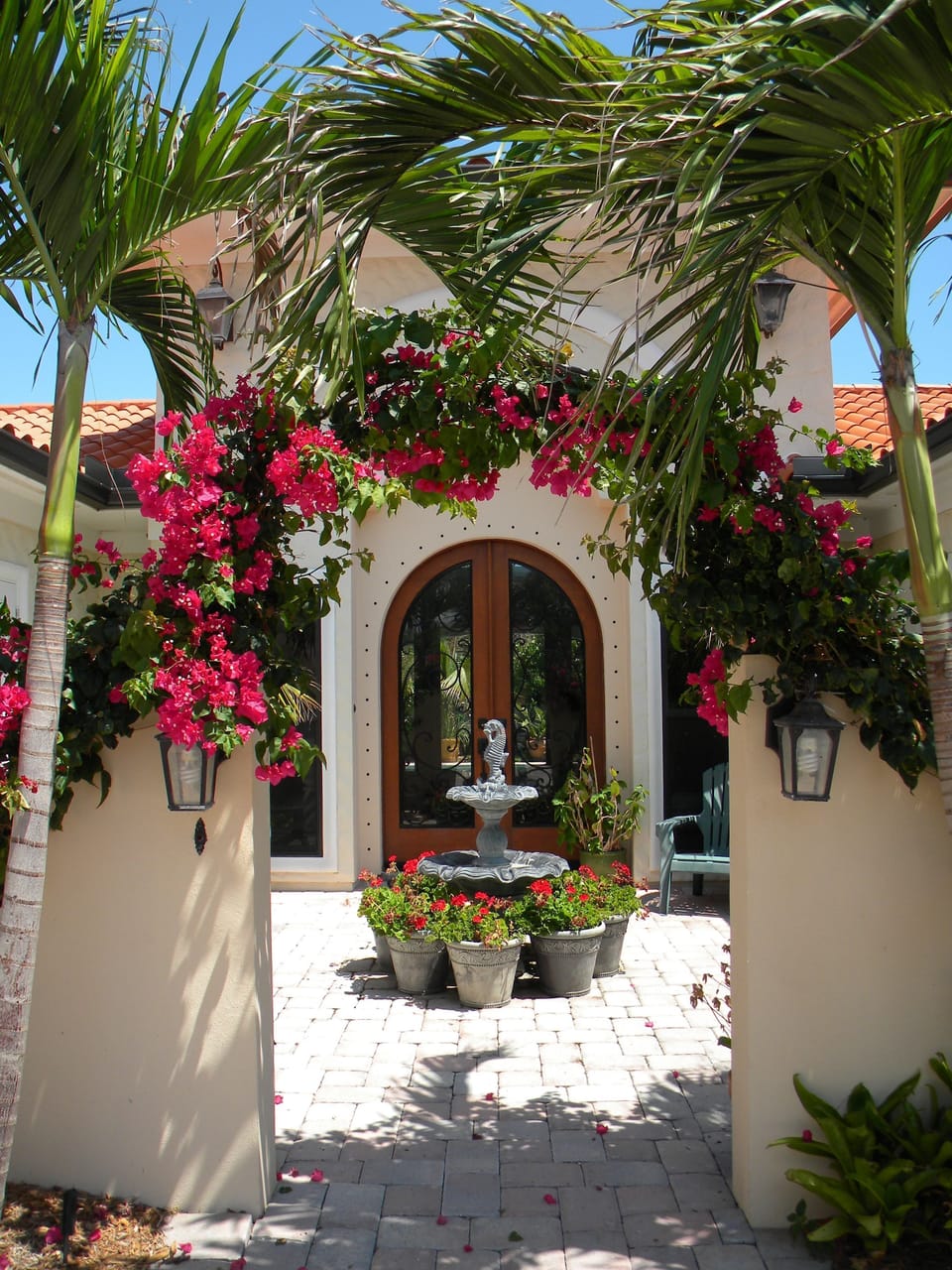 Mediterranean influenced entry courtyard with waterfall