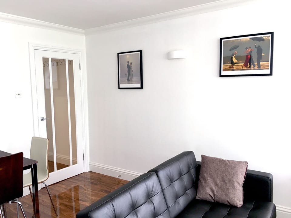 Living room: double aspect, with sofas, TV, dining table and 6 chairs