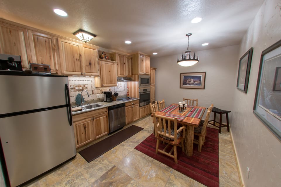 Modern kitchen w/new stainless steel appliances, dishes, pots/pans, and staple