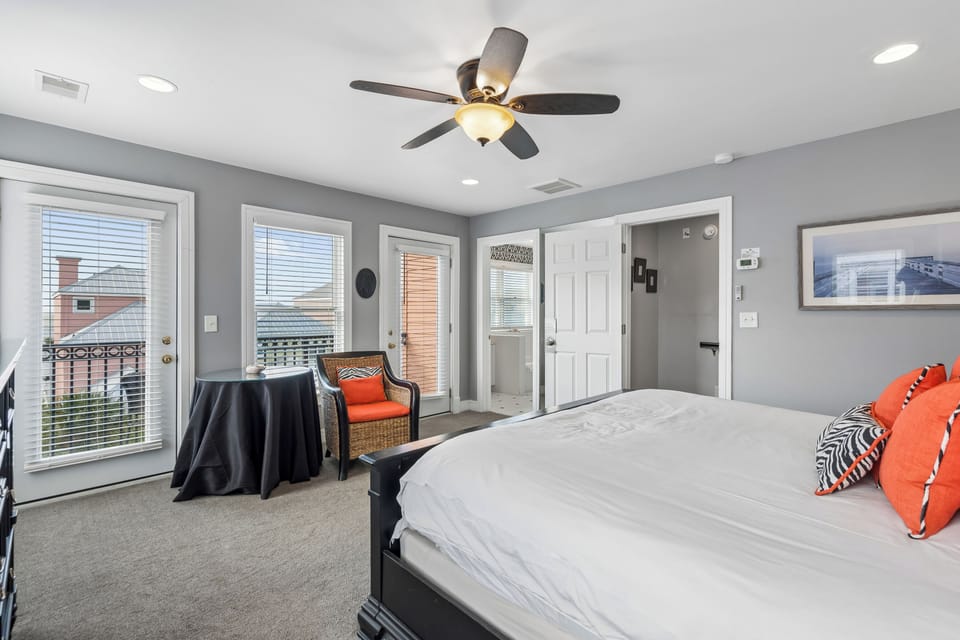 Unwind in your spacious master suite with city views, where gray walls and orange accents create a calming retreat.