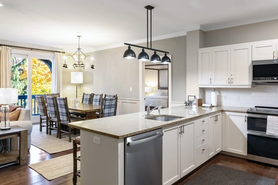 - Modern kitchen with stainless steel appliances and granite counters   - Open layout connects to dining and living areas for easy entertaining   - Fully equipped for family meals and après-ski gatherings