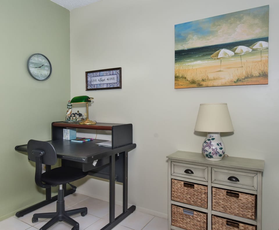 Office area with desk and small drawers.
