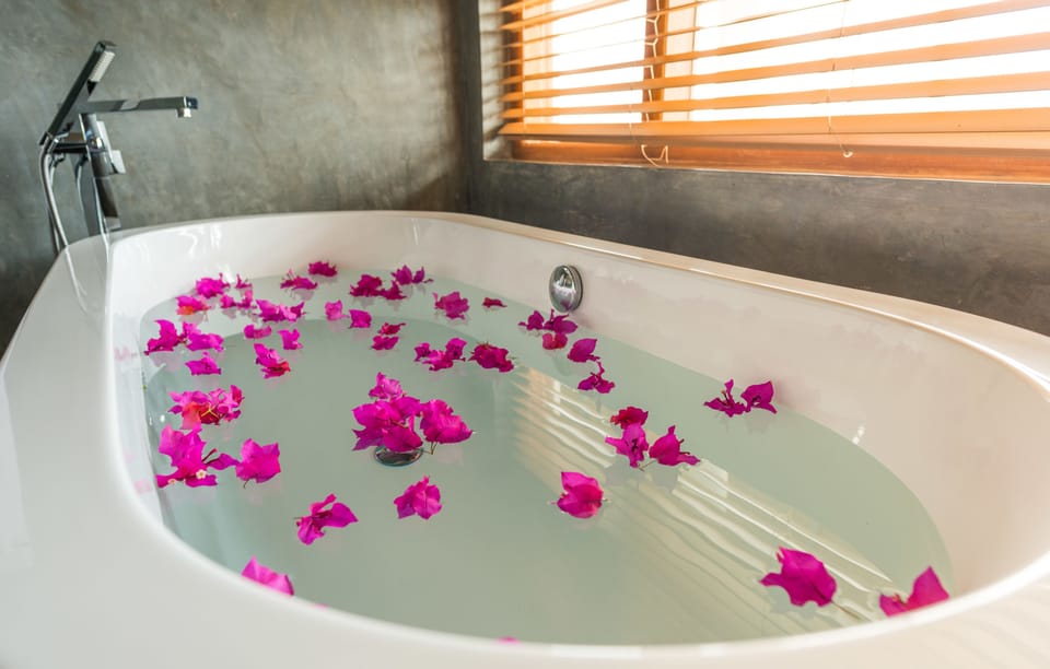 Panoramic Suite | Bathroom | Rainfall showerhead, free toiletries, slippers, towels