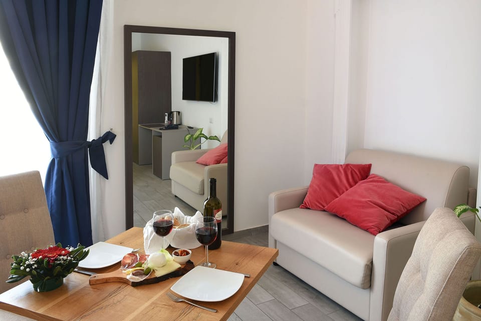 Suite, Hot Tub | Living room | 55-inch flat-screen TV with cable channels, TV, first-run movies