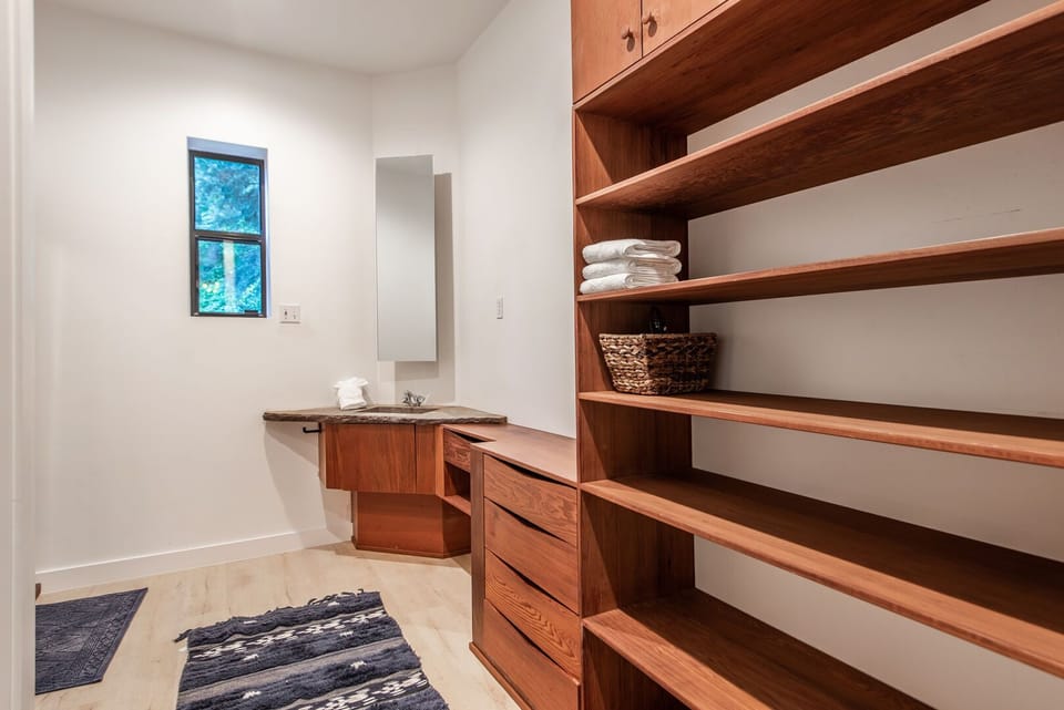 Upper level Master Bathroom features two separate vanities connected by large walk-in shower.