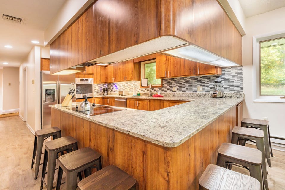 Beautiful eat in kitchen fully stocked to cook and serve for family gatherings.