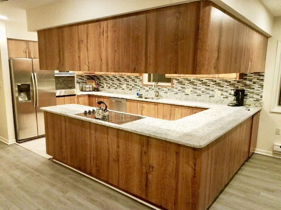 Beautiful eat in kitchen fully stocked to cook and serve for family gatherings.