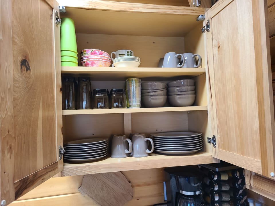 Upper cabinet right of sink.