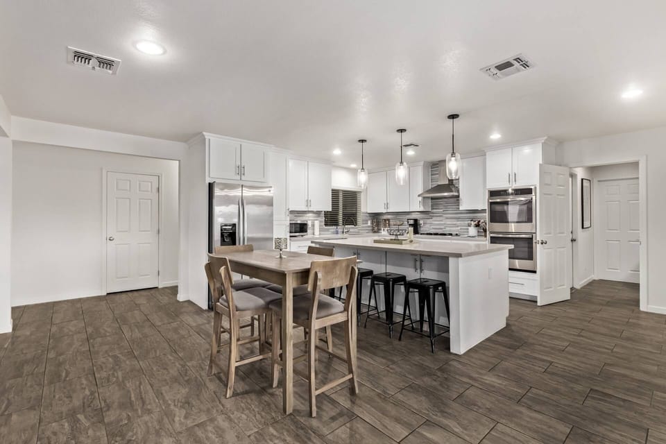 Extra seating for 4 just off the kitchen plus 4 barstools at the kitchen counter