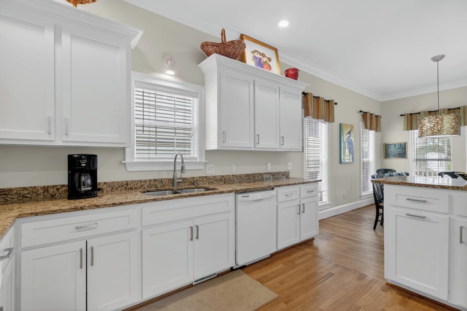 Prepare your favorite meals in this bright, fully equipped kitchen, complete with granite countertops, modern appliances, and plenty of cabinet space for a comfortable stay.