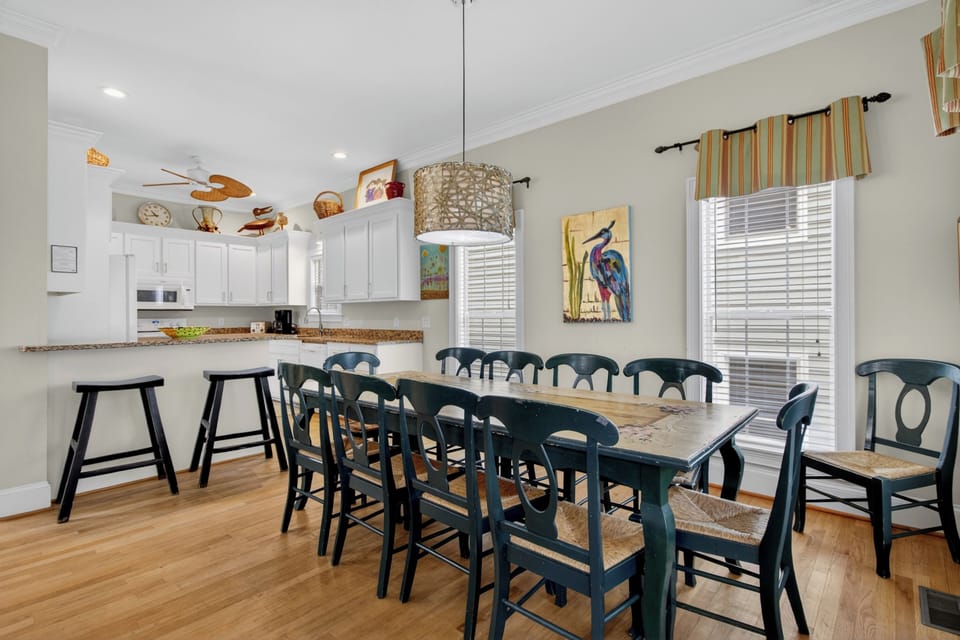 Your spacious open-plan kitchen and dining area welcomes everyone—bright, airy, and perfect for gathering around the large table with seating for the whole group.