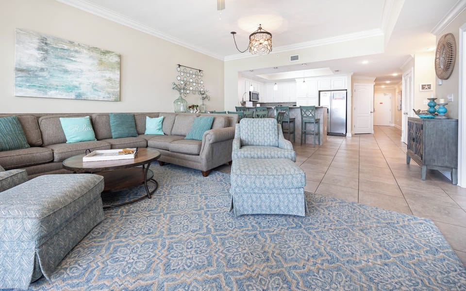 Relax in the spacious living area with a comfortable sectional, stylish decor, and easy access to the dining area