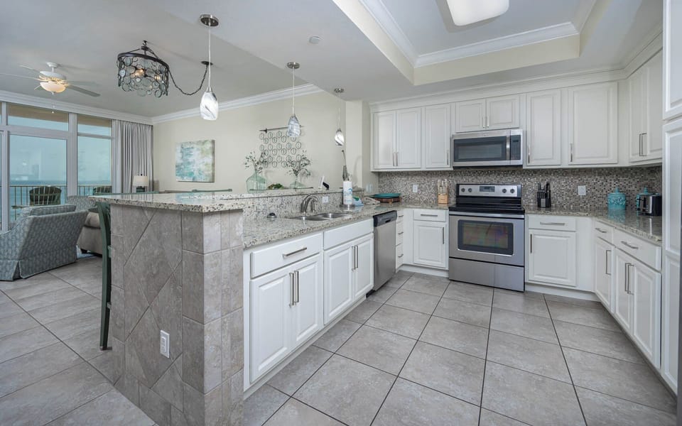 Prepare meals in the stylish kitchen with stainless appliances and a beachfront view