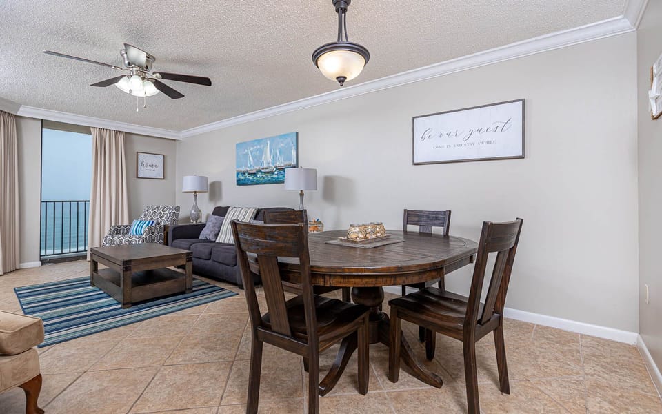 Relax in the inviting living area with comfortable seating, a dining table, and beautiful beachfront views