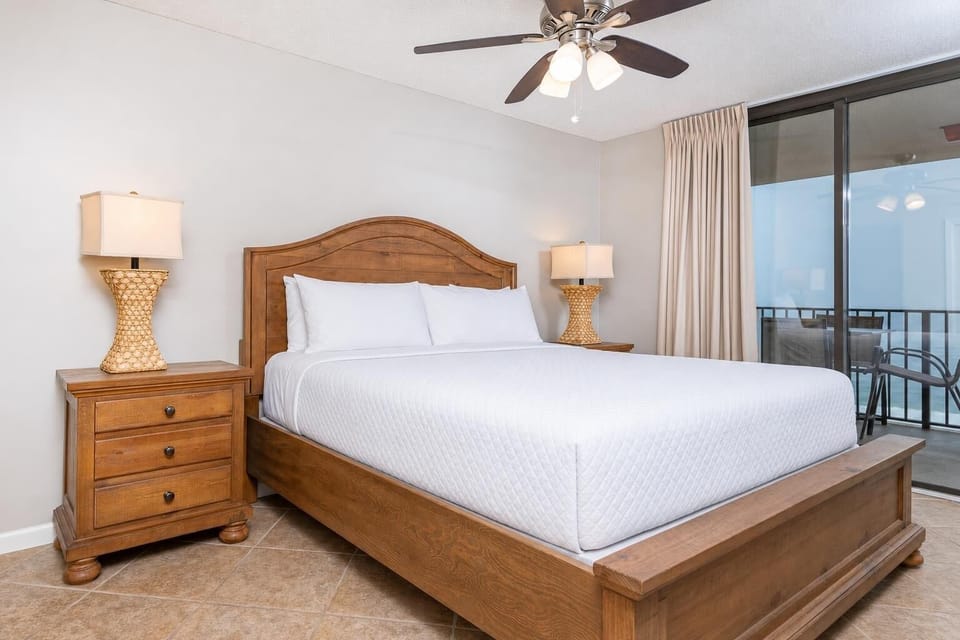 Unwind in this master bedroom featuring a comfortable king bed, stylish decor, and access to the beachfront balcony