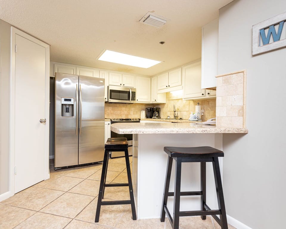 Enjoy preparing meals in this spacious kitchen with stainless appliances and a convenient breakfast bar