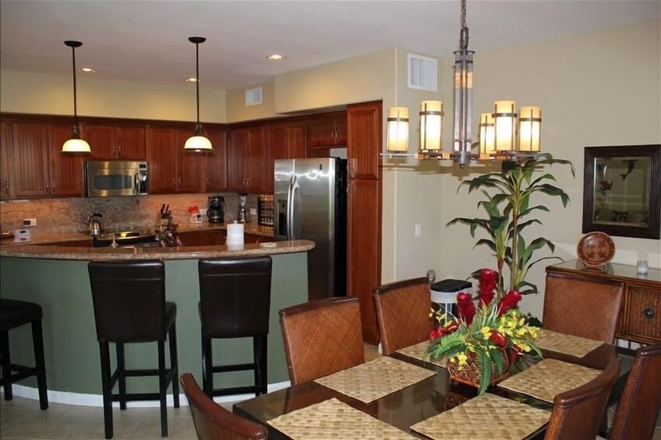 Dining table adjacent to kitchen. 