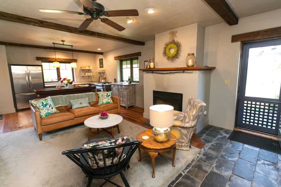 Full view of living and kitchen with screen door out to water view entrance.