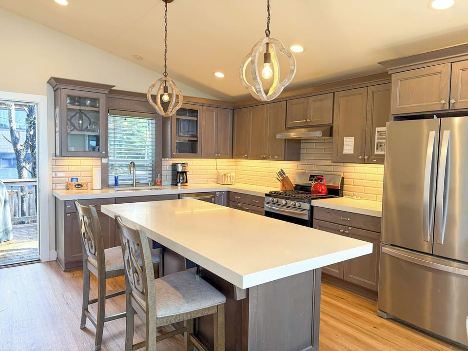 Kitchen with exit to the back deck with grill