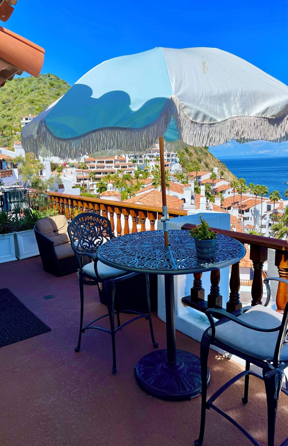 - Sip wine or morning espresso beneath a fringed umbrella with views that stretch to forever
- Perched above red tiled rooftops with hills & waters in every direction
- Elegant seating invites you to linger, relax, & soak in the Mediterranean style magic