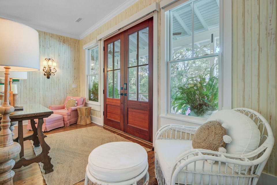 Sink into this cozy sunroom where comfortable seating and garden views create your perfect morning coffee retreat.