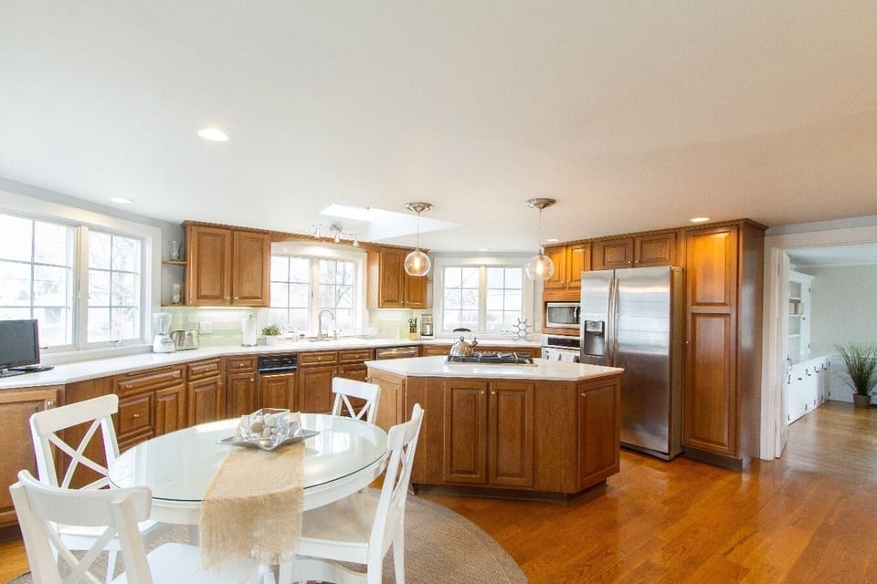 Kitchen with glass subway tiles and stainless steel appliances