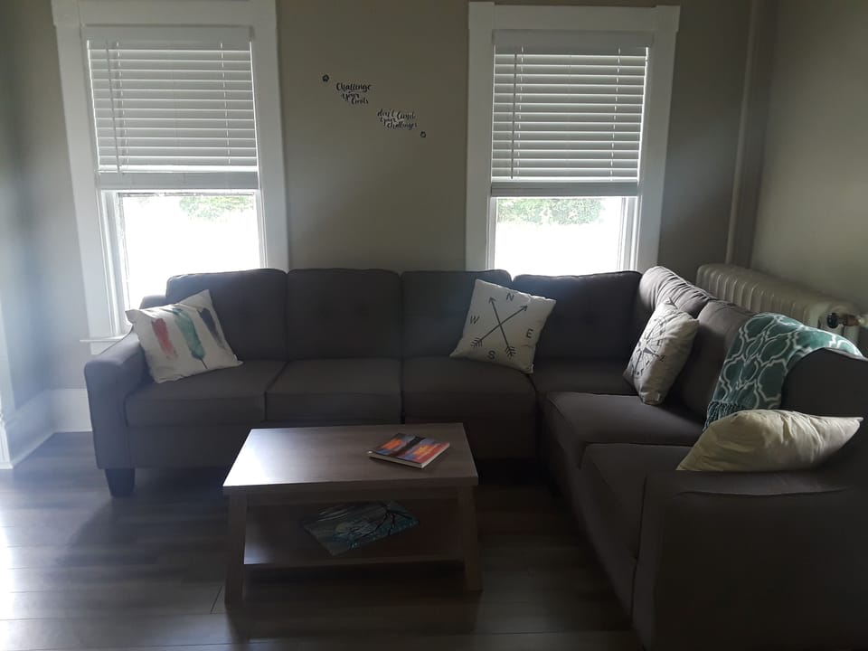 sectional and living room. twin cot in closet