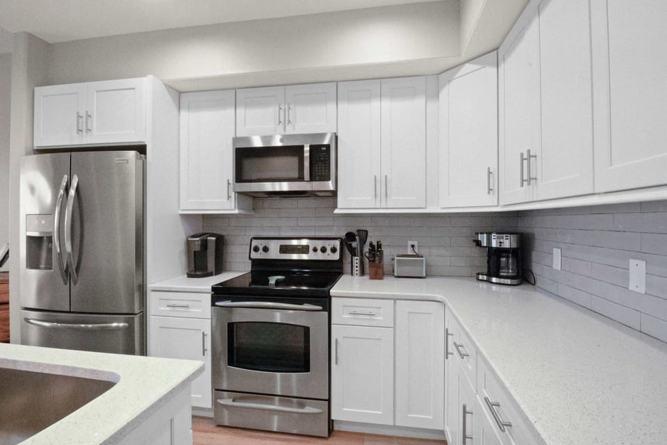 Lovely, remodeled kitchen with Stainless Steel appliances and solid surface quartz countertops. 