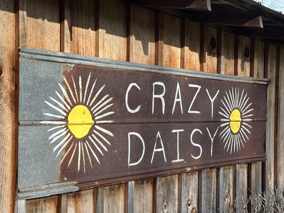 Charming rustic sign welcomes you to Crazy Daisy retreat