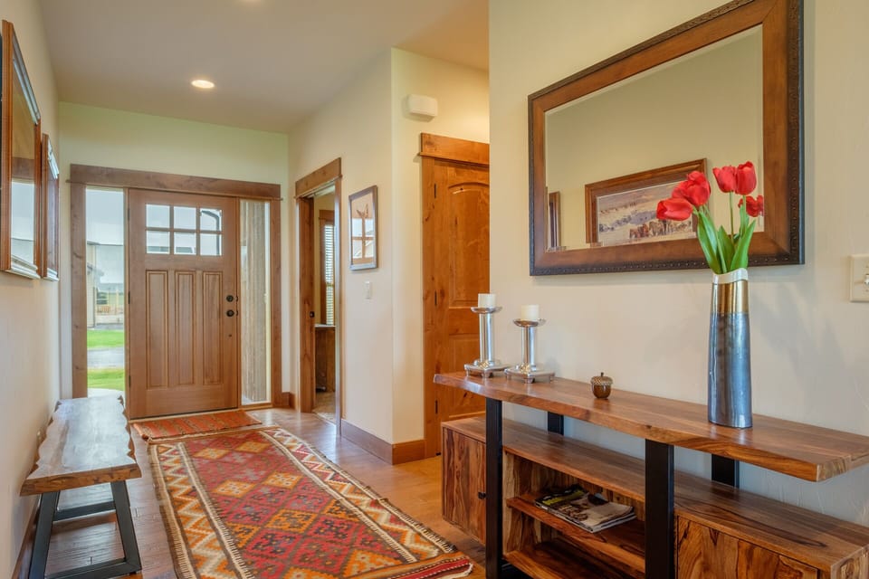 Elegant entry hall has mirror and artwork- this view is towards the front door