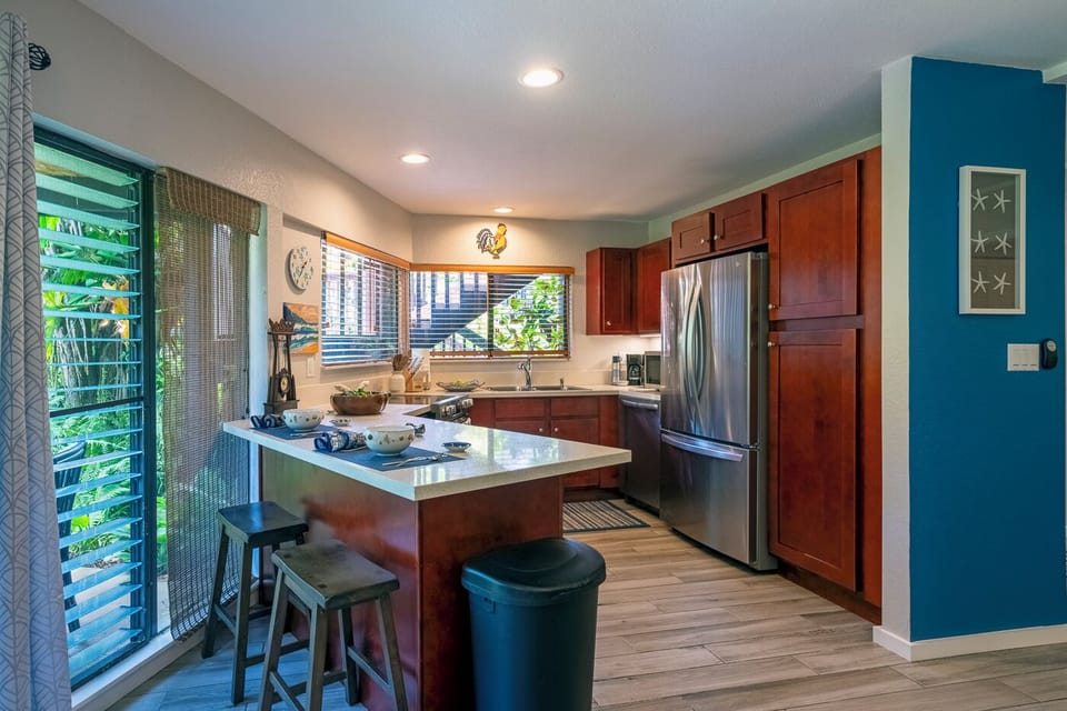 Kauai vacation rentals | Mauna Kai condos | kitchen - Everything you need is in the well appointed kitchen: full size fridge/freezer, dishwasher, microwave, toaster, drip coffee pot, all the pots/pans, dishes, and utensils you may need, and a small selection of basic cooking supplies.