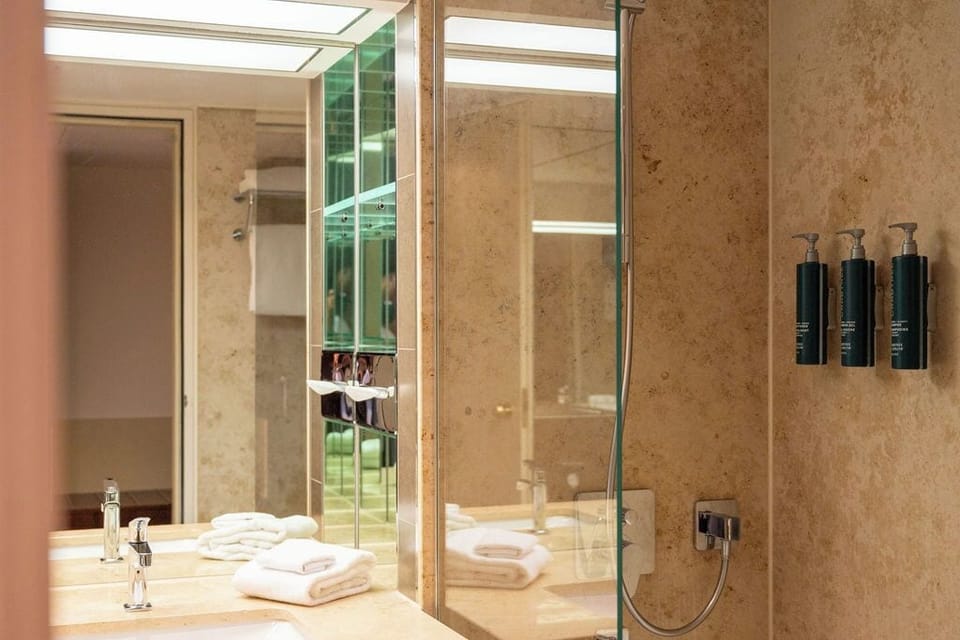 Suite, 1 King Bed | Bathroom | Eco-friendly toiletries, hair dryer, bathrobes, slippers