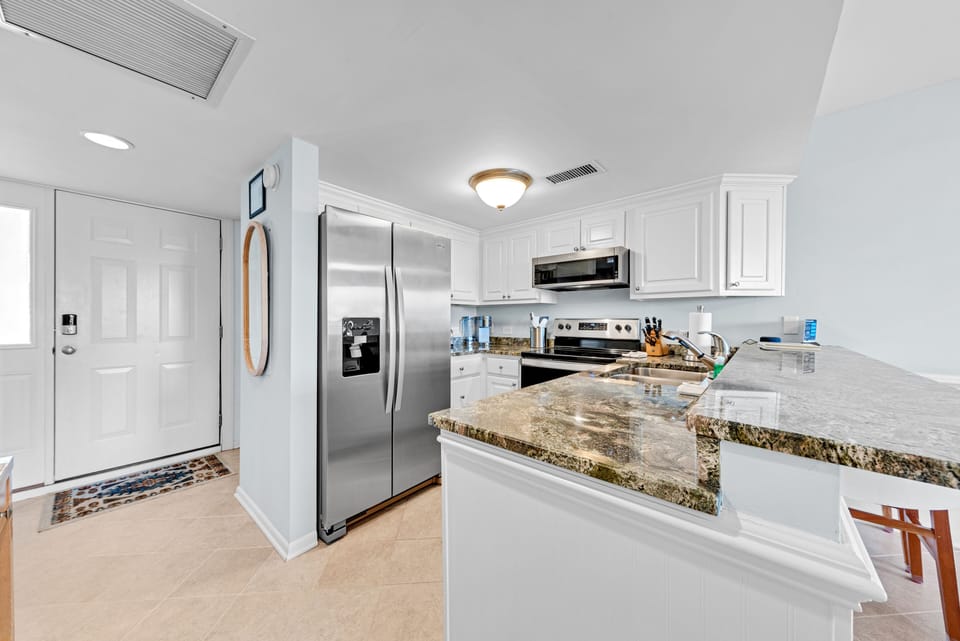 The kitchen is fully stocked and has stainless steel appliances!