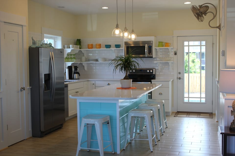 Custom island with retro metal bar-stools.